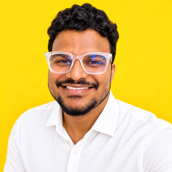 Balamurugan Manoharan smiling in a white shirt