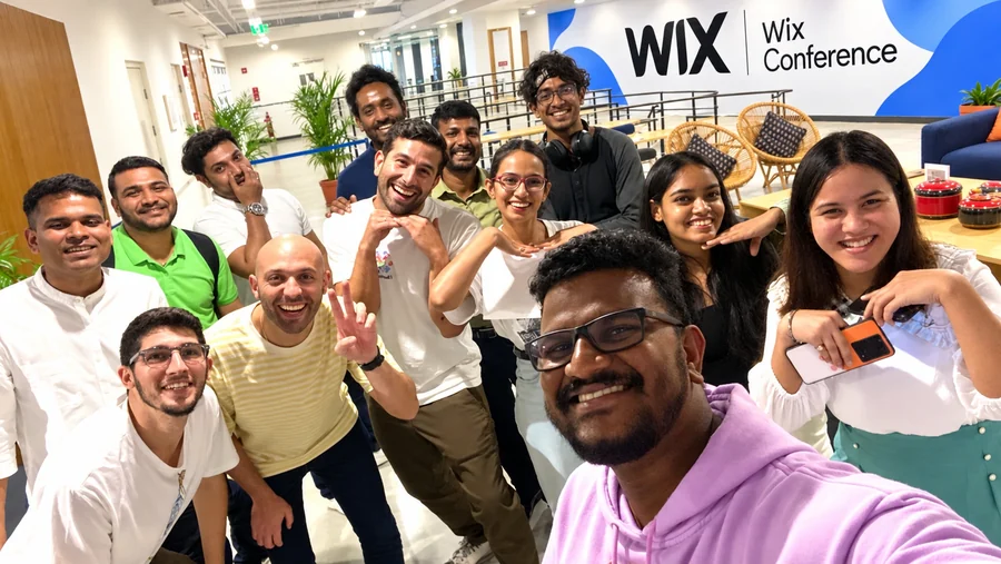 Bala taking a group selfie at a Wix conference